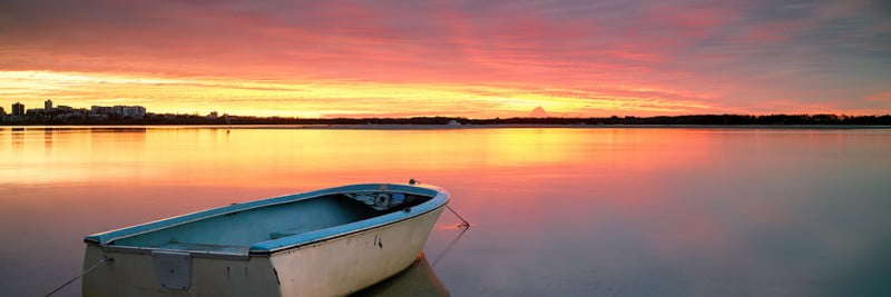 Lone Boat at Sunrise